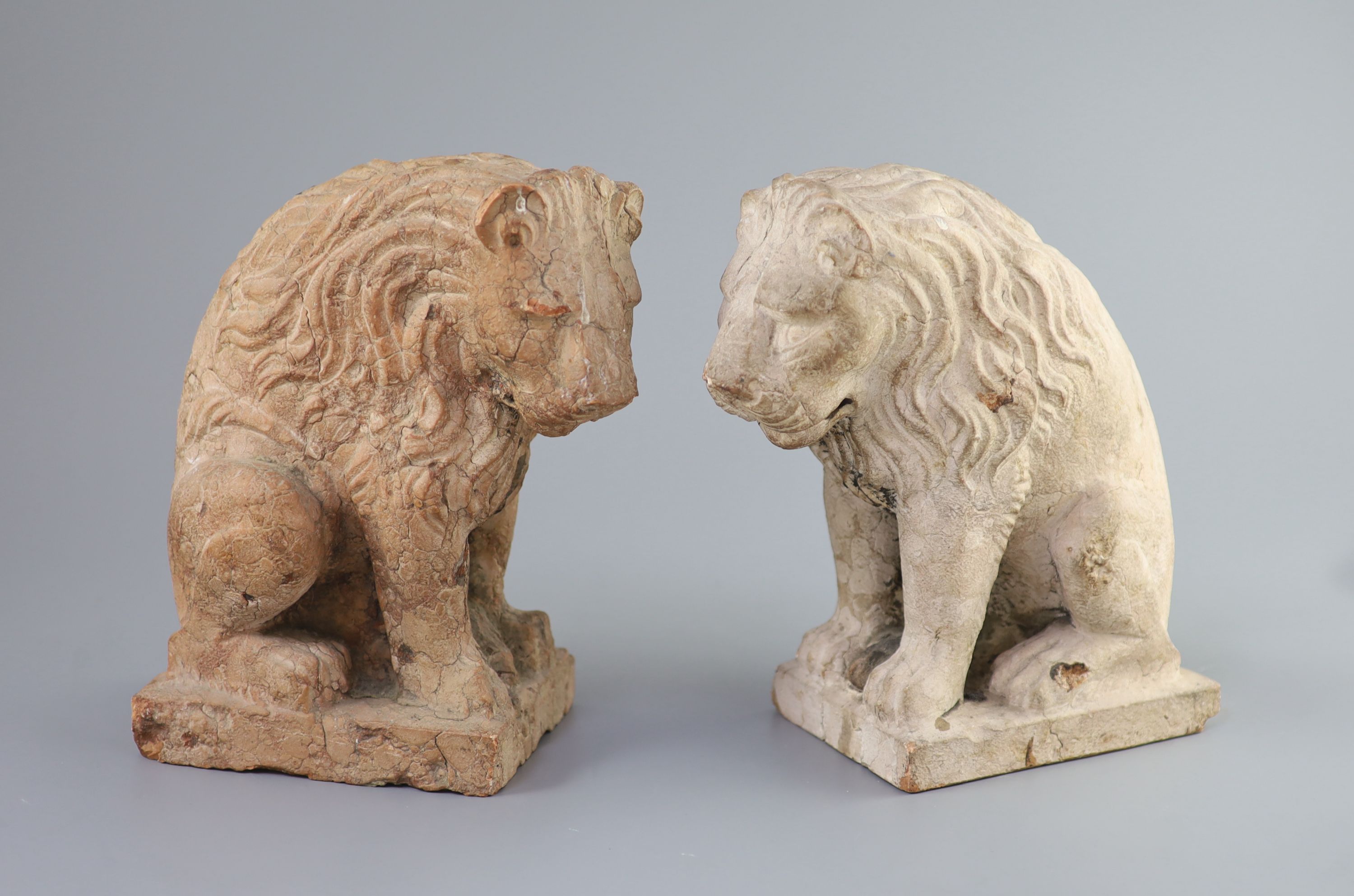 A pair of European pink marble seated lions, 18th century or earlier, 25cm high